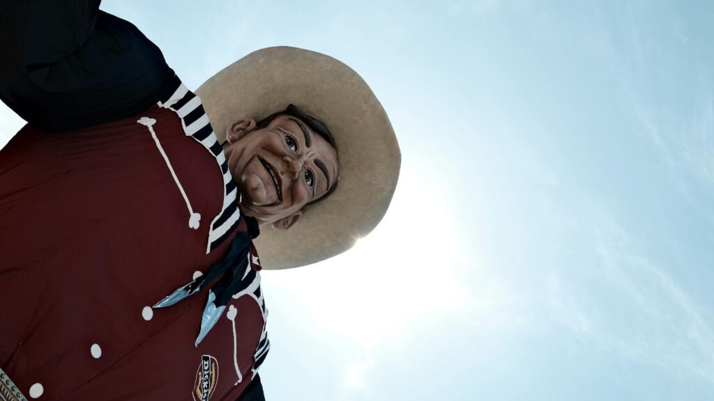 Big Tex with the sun shining behind him.